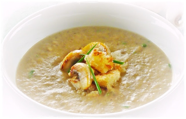 mushroom soup with fried mushrooms and crouton garnish