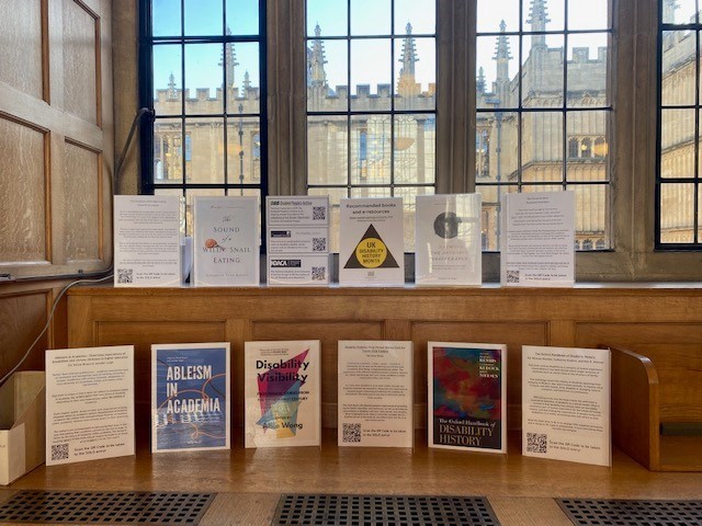 A display including fact sheets and images of suggested titles such as Ableism in Academia and The Oxford Handbook of Disability History