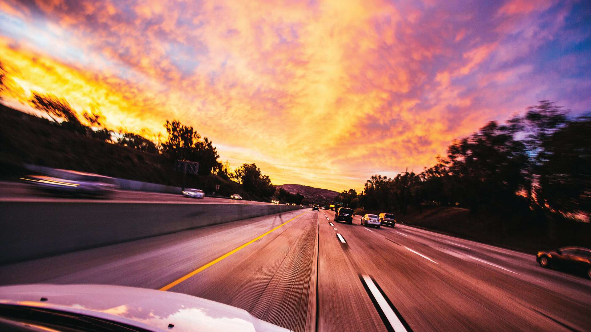 Cars speeding down the highway.