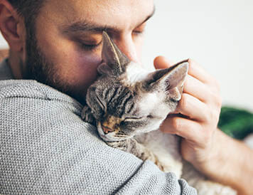 pet parent holding kittne