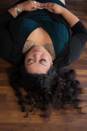 A fat woman laying on her back looking peaceful during a portrait photo session in Seattle