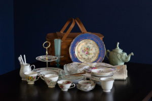 A tea set and picnic basket laid out on a table during a small business photo session in the PNW