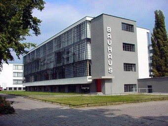 Gray and white building with a wall made of windows