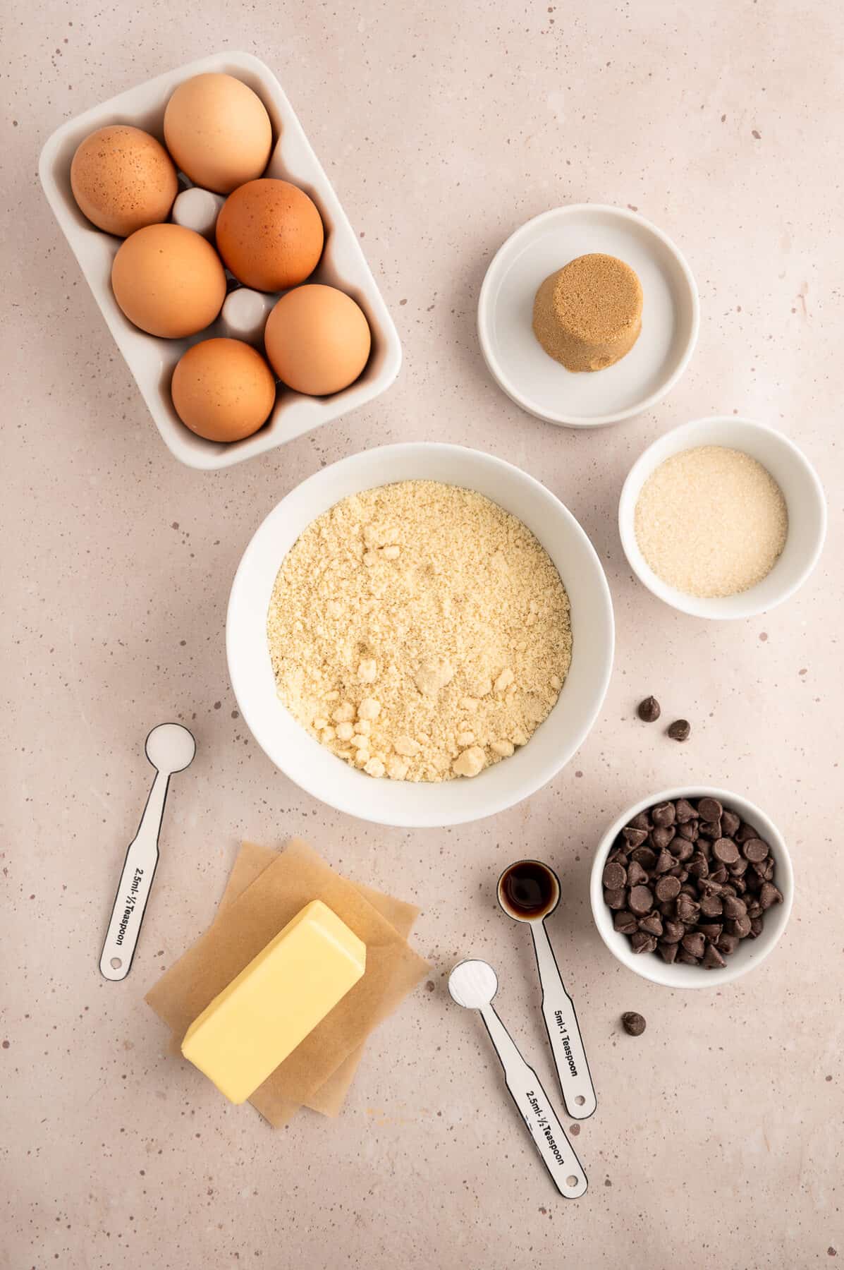 ingredients for almond flour chocolate chip cookies in white ceramic bowls. 