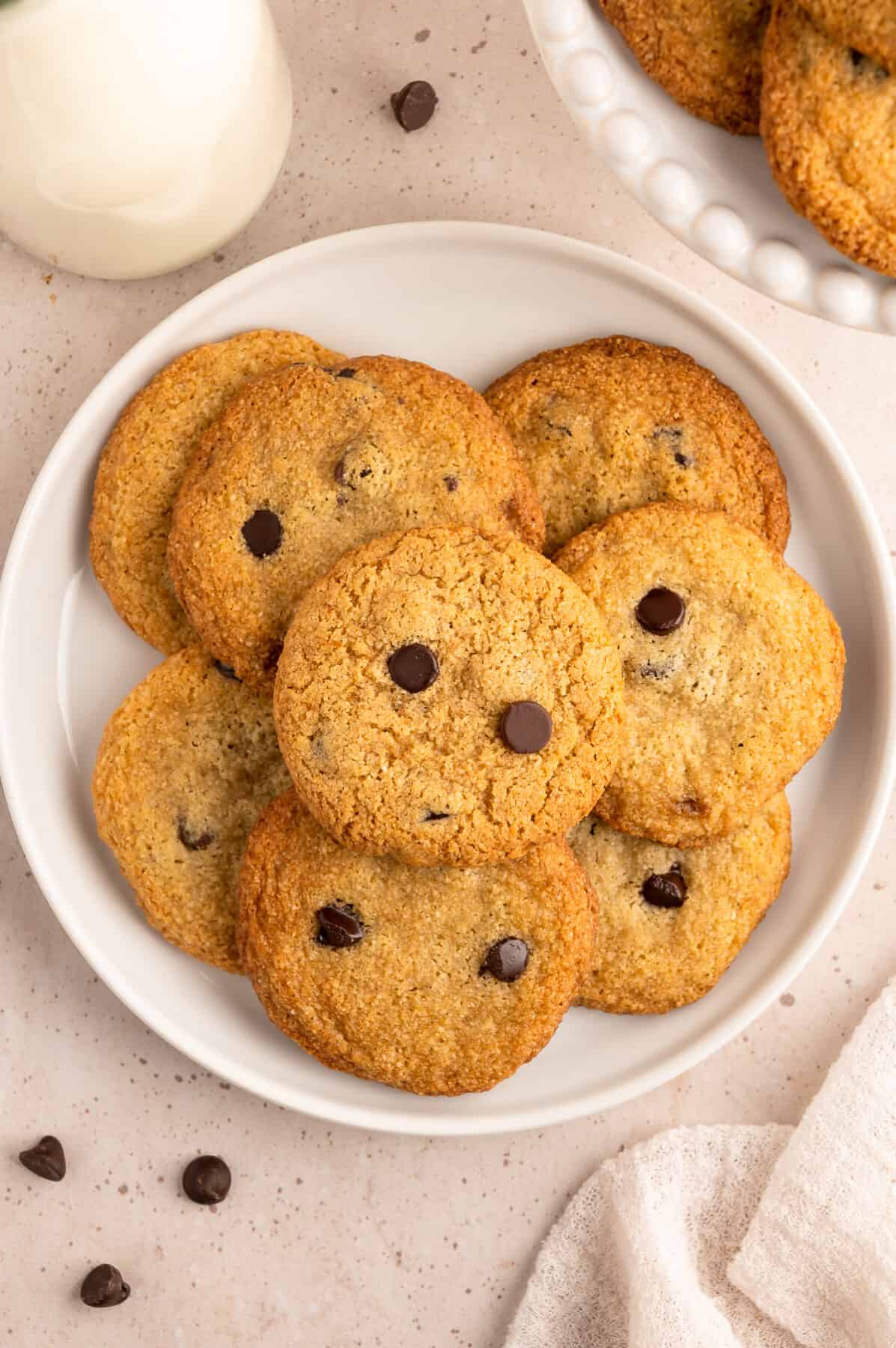 almond flour chocolate chip cookies stacked on a white plate. 