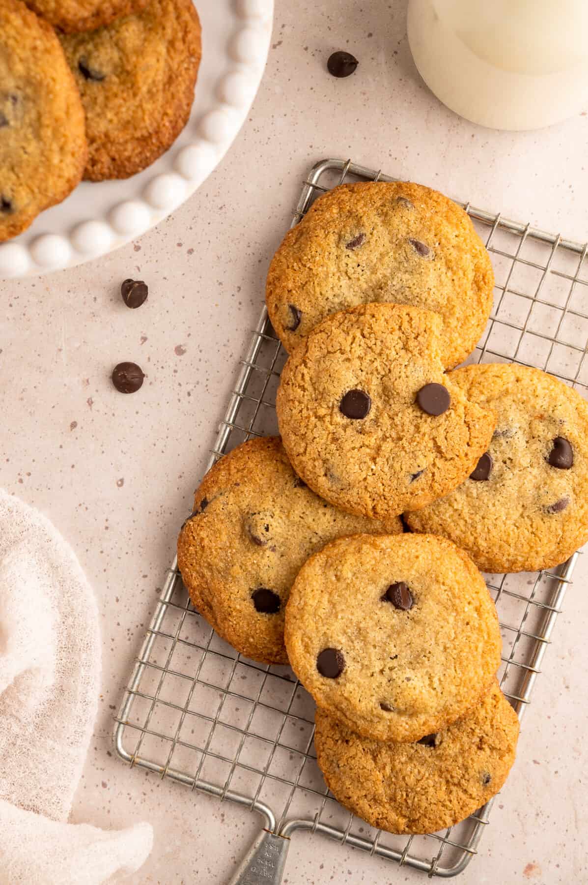 chocolate chip cookies stacked on a wire rack.