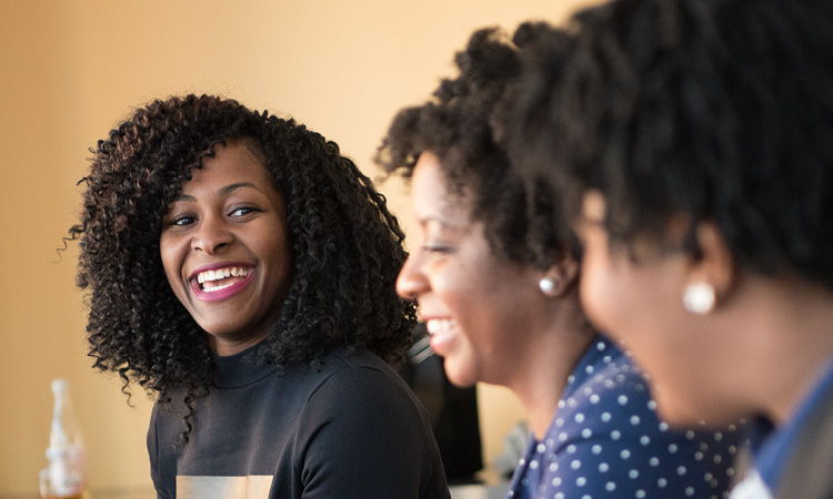 A group of Black women smiling