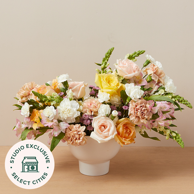 mixed floral arrangement in yellow, white, pink and other pastel colors