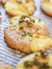 Smashed potatoes on sheet pan that have been baked until crispy.