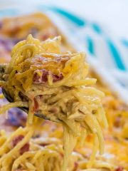 Spoon filled with chicken spaghetti over casserole dish.