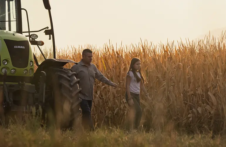 farmer walking through a field in greece 