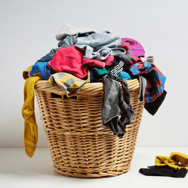 wicker laundry basket full of stained clothes