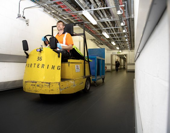 A member of the Estates team driver a tug which are used on Level 1 to transport equipment underneath the corridors of the hospitals