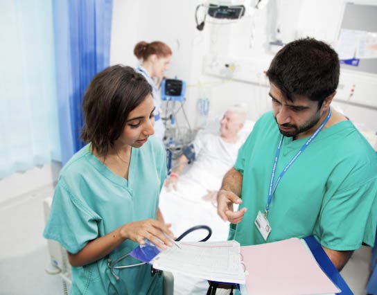 two doctors on a ward chatting