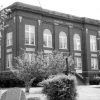 Three-story brick building labeled "Franklin County" with trees in bloom