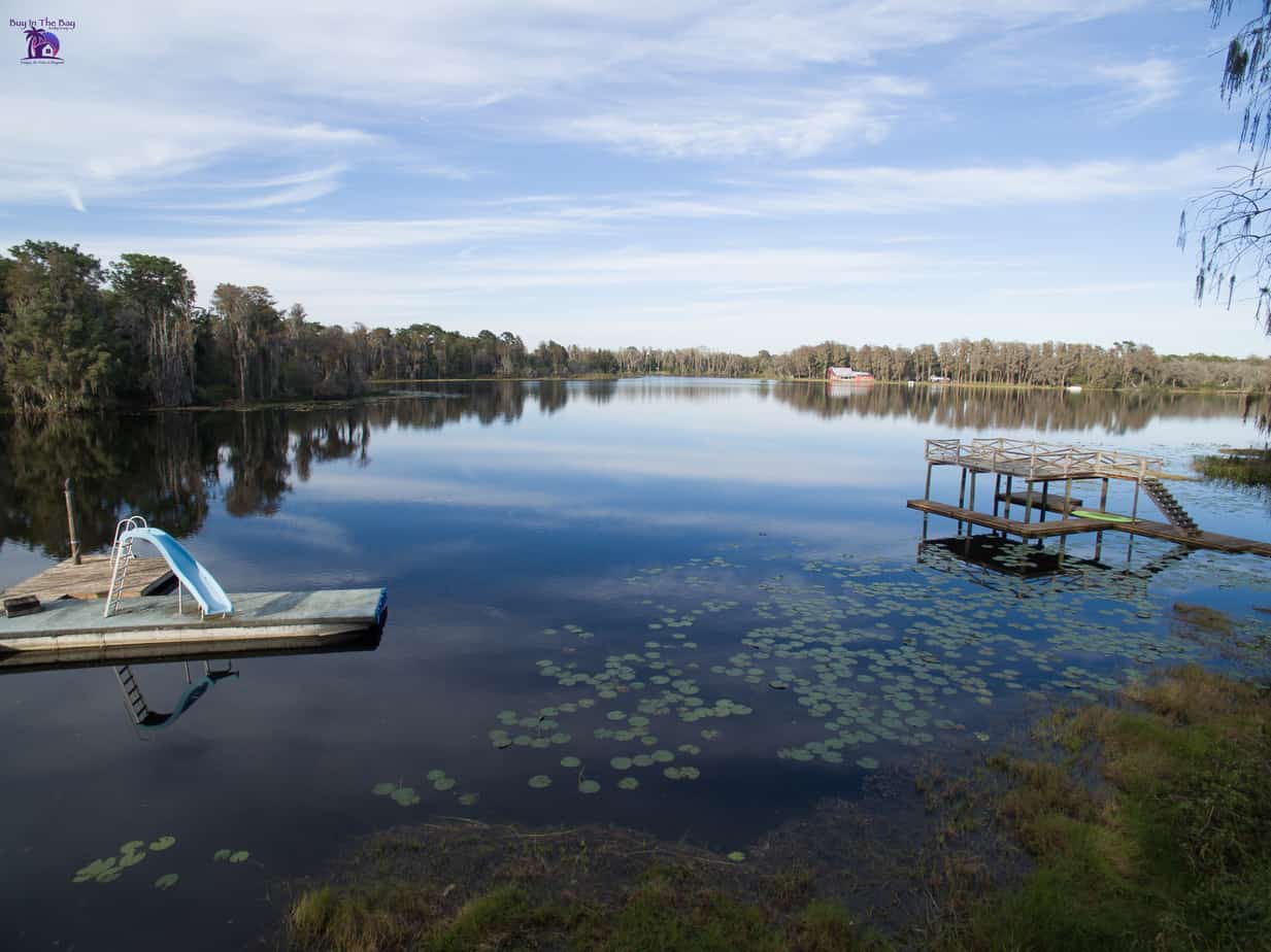 picture of rainbow lake in ofessa florida with trees and a floating slide