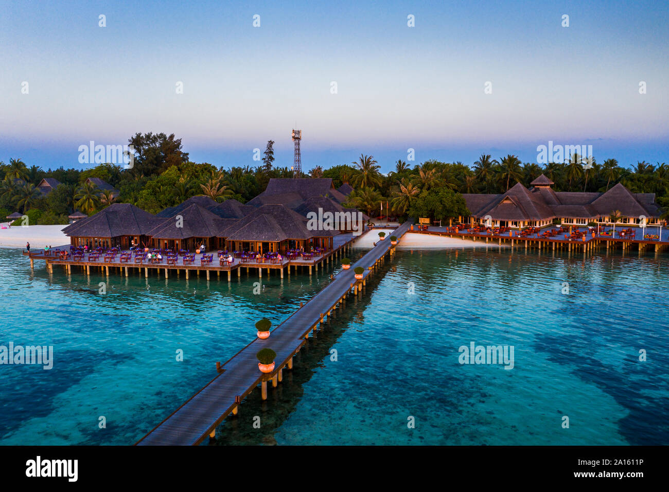 Maldives, Olhuveli island, Pier and resort on South Male Atoll lagoon at sunset Stock Photo