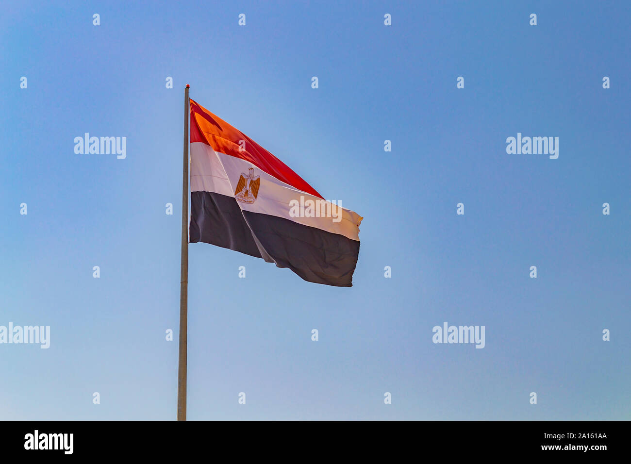 Flag of Egypt on flagpole against clear blue sky. Sharm-el-Sheikh, Egypt Stock Photo