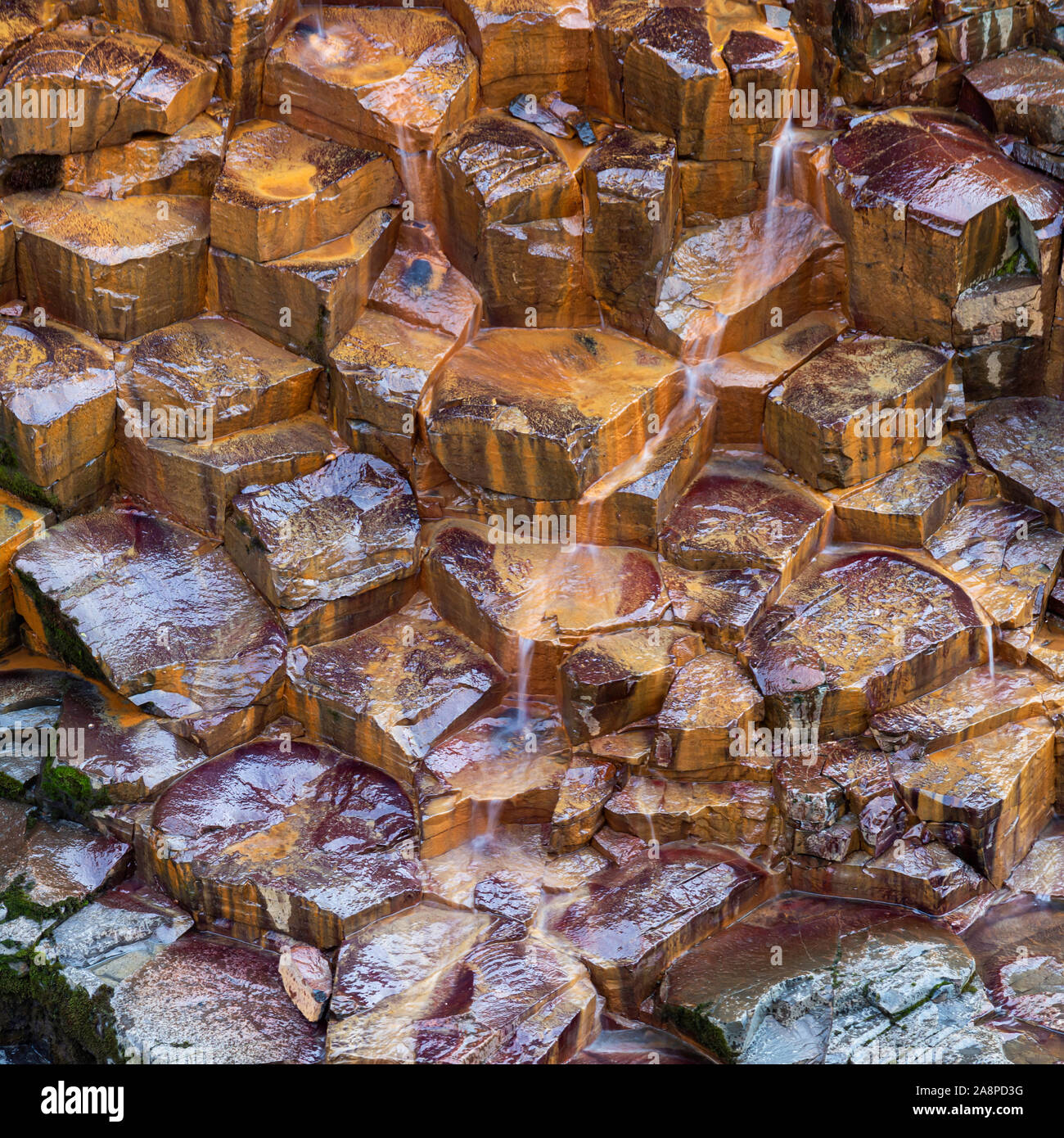 Basalt Columns with water flowing in Iceland Stock Photo