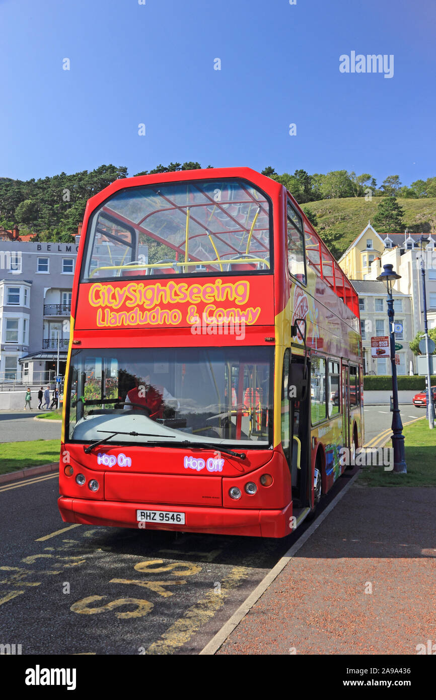 Old red double deck bus offering city tours of Llandudno and Conwy Stock Photo