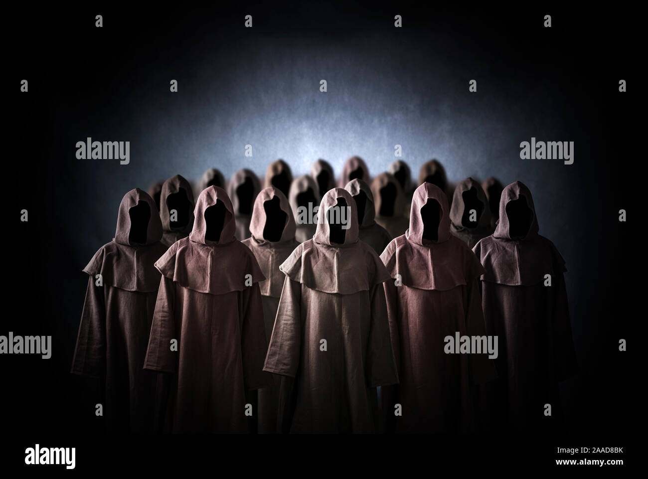 Group of scary figures in hooded cloaks Stock Photo