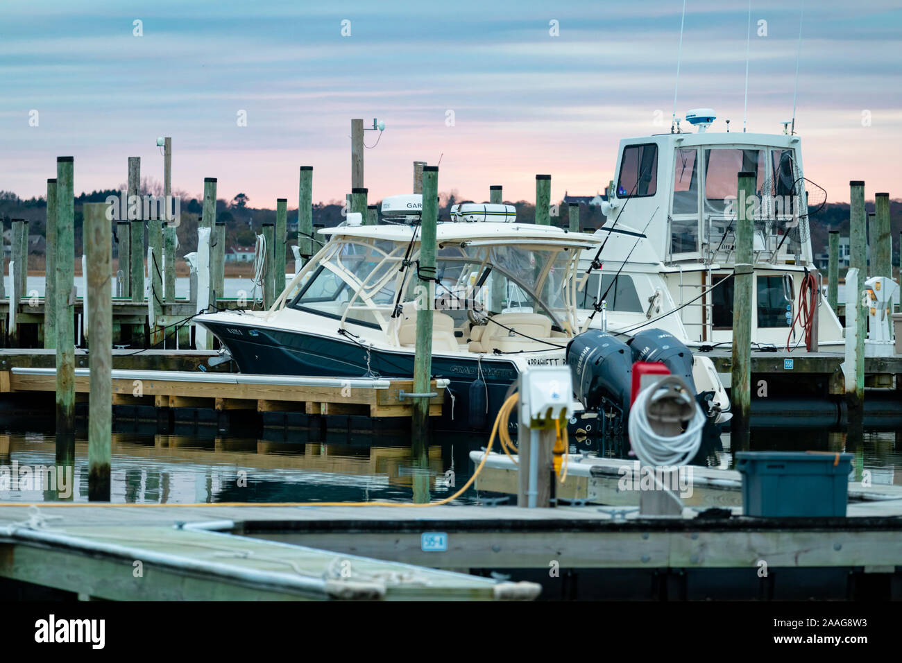 View of boats docked in marina at sunset Stock Photo