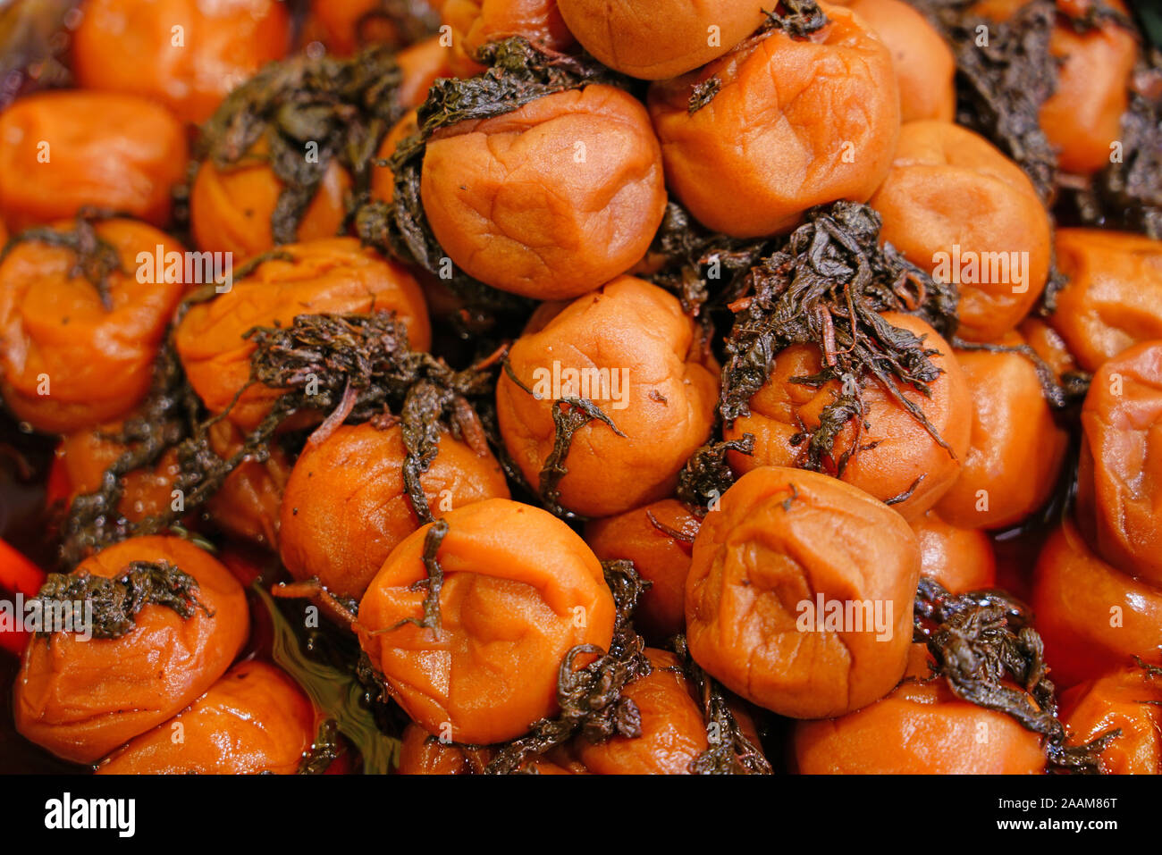 Pink umeboshi pickled ume plums with shiso Stock Photo