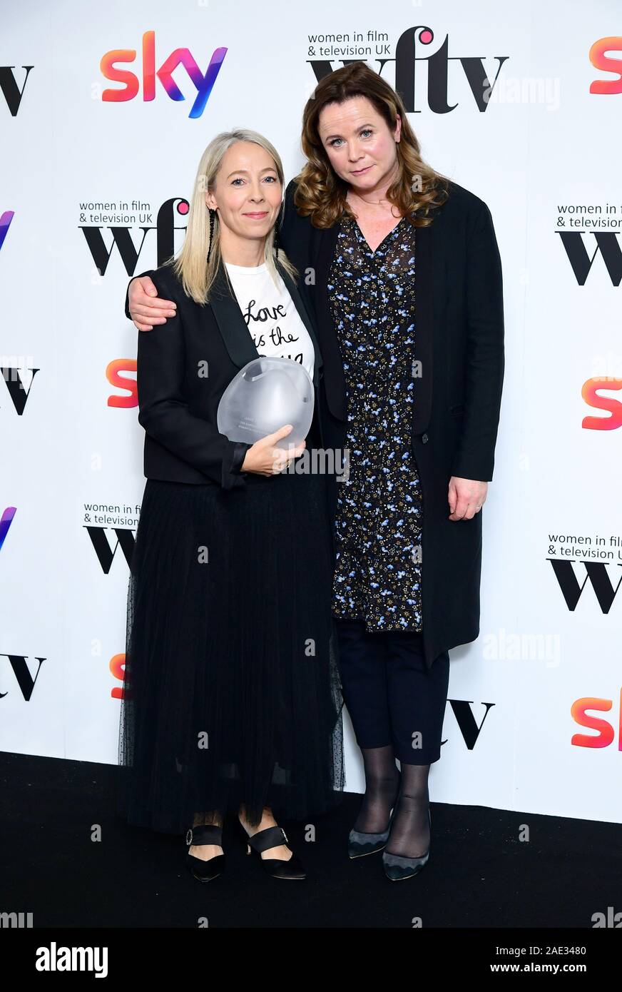 Jane Featherstone with her Barclays Business Award in the press room with Emily Watson at the Women in Film and TV Awards 2019 at the Hilton, Park Lane, London. Stock Photo