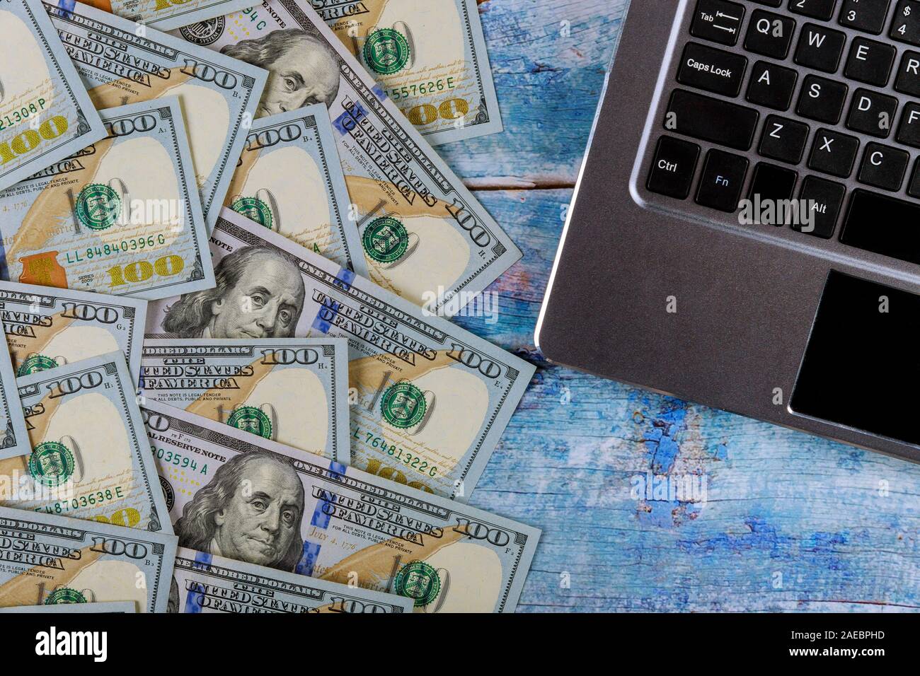 Paper money 100 dollar bills on laptop modern computer keyboard financial concept Stock Photo