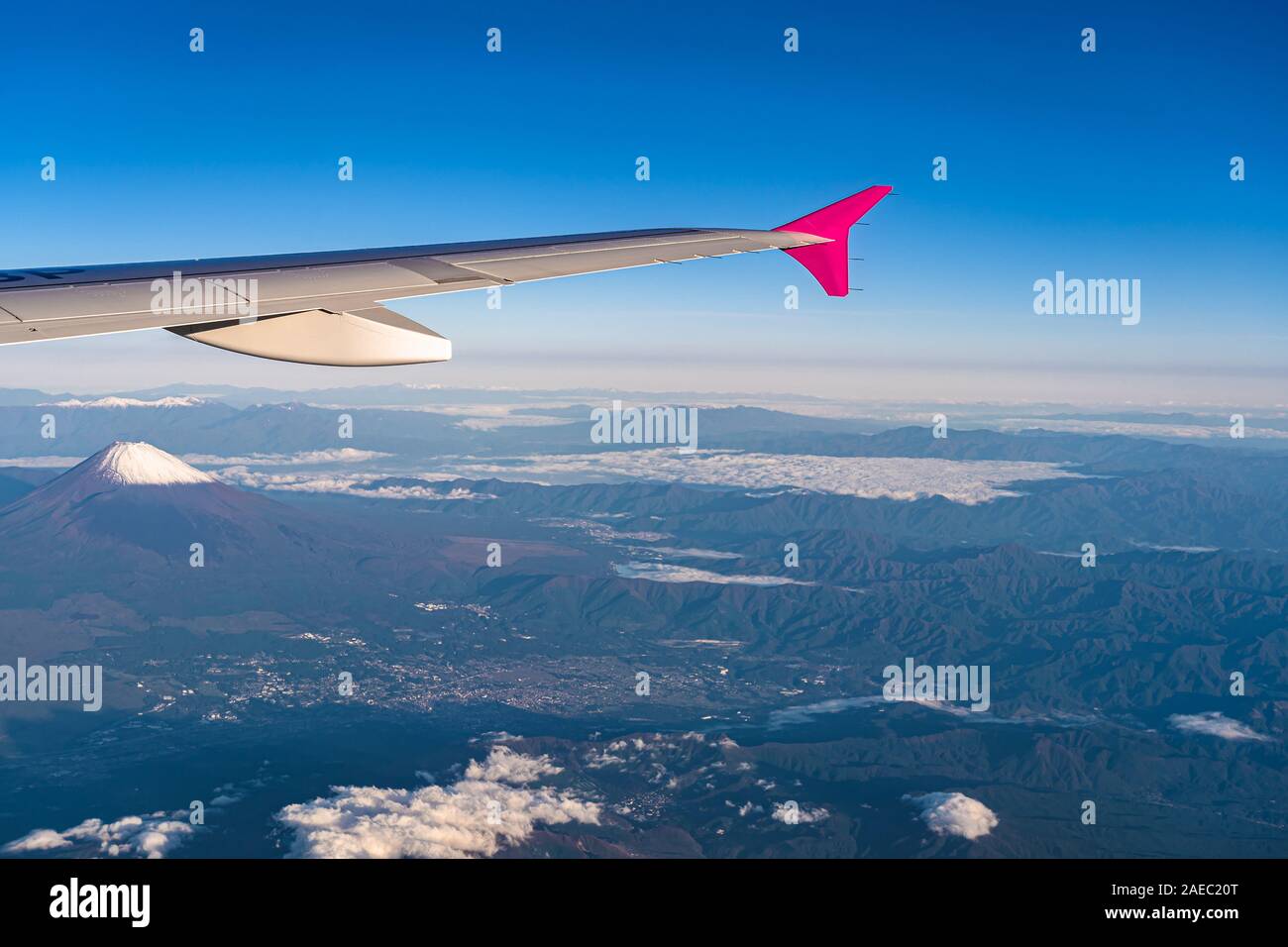 Aerial view of airplane wing with Mount Fuji ( Mt. Fuji ) in background and blue sky. Scenery landscapes of the Fuji-Hakone-Izu National Park. Gotemba Stock Photo