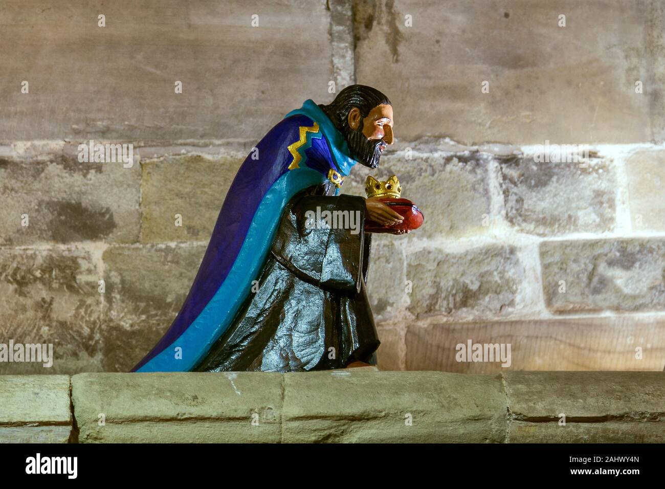 A Christmas decoration of Casper, one of the three wise men, carrying a gift of a gold crown. Stock Photo