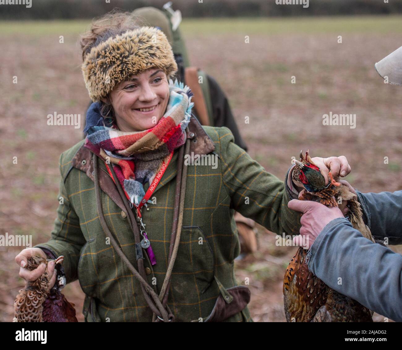 lady hunter with dead pheasants Stock Photo