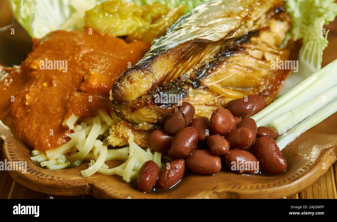 Kenkey with fried fish and chili pepper, Ghanaian cuisine, Traditional assorted African dishes, Top view. Stock Photo