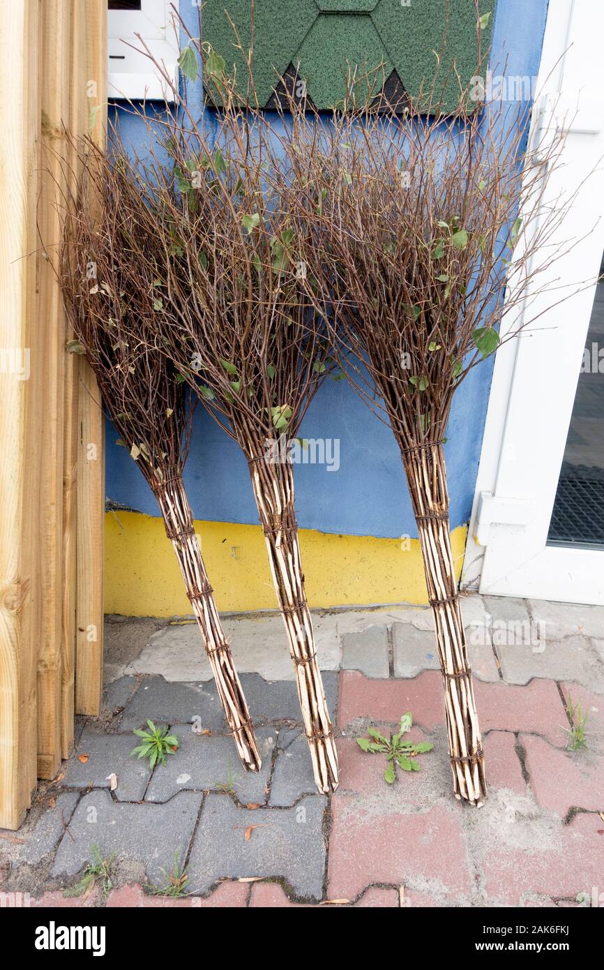 Handmade and decorative brooms for sale at hardware store. Rzeczyca Central Poland Europe Stock Photo