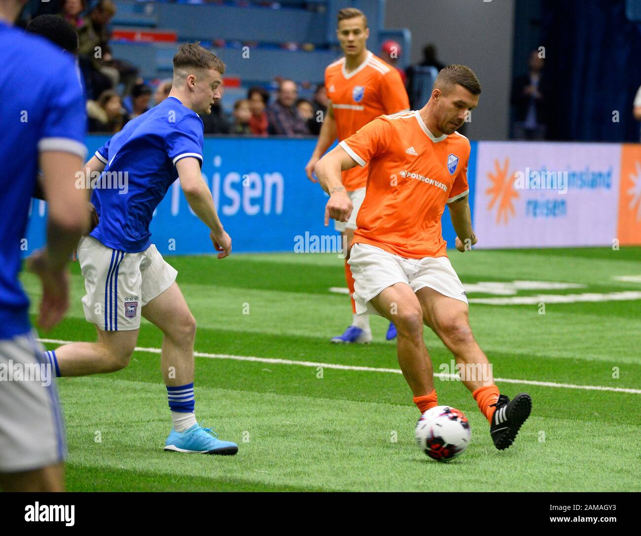 Gummersbach, Germany. 12th Jan, 2020. Football: Indoor tournament, with interlude by Lukas Podolski. Football World Champion Lukas Podolski, r, shoots the ball for his guest team, RSV Meinerzhagen, during the Schauinsland reisen Cup against Ipswich Town from England. Credit: Roberto Pfeil/dpa/Alamy Live News Stock Photo