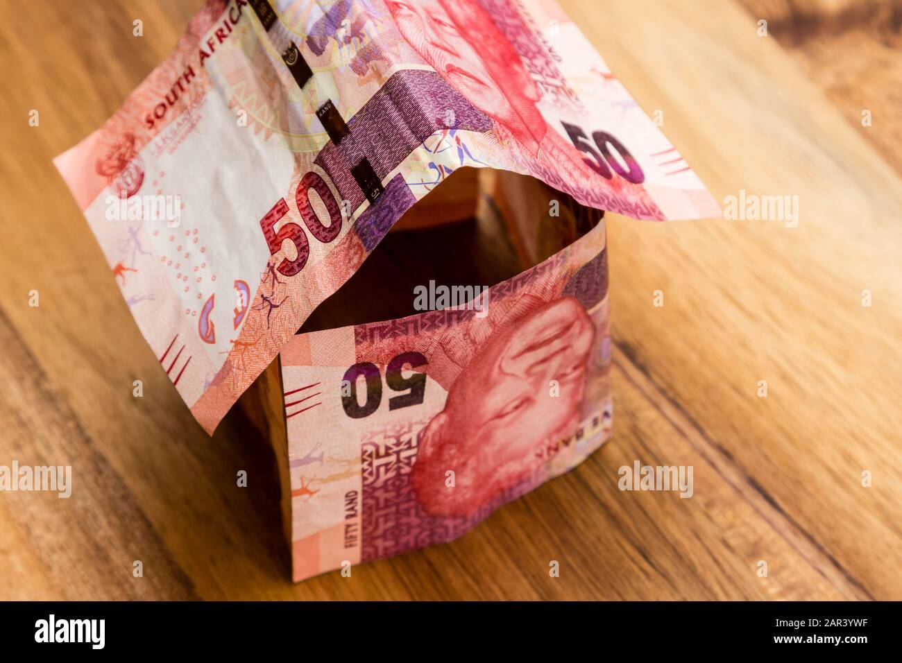 High angle shot of some South African rand bills on a wooden surface Stock Photo