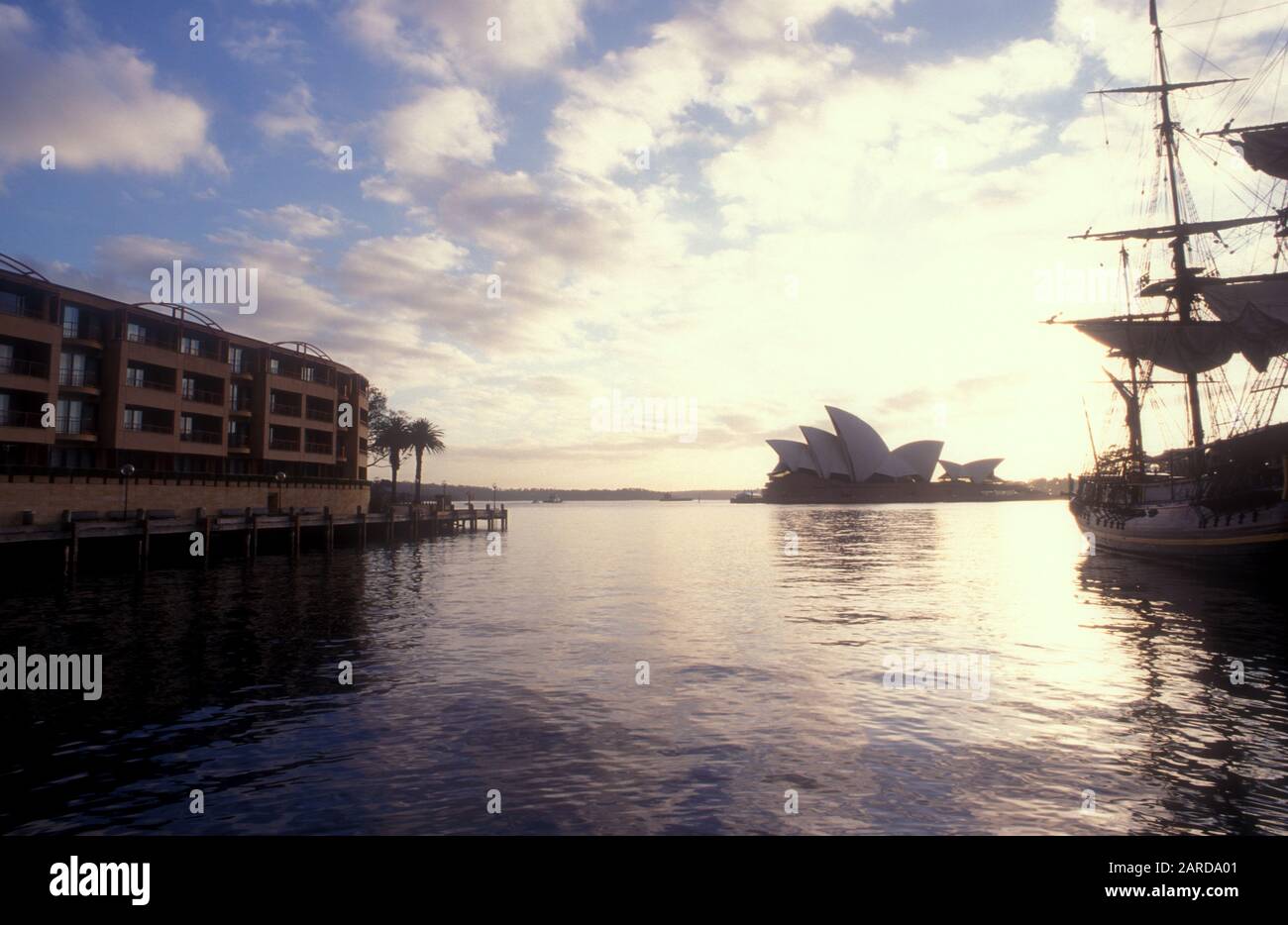 EARLY MORNING VIEW TO THE SYDNEY OPERA HOUSE WITH REPLICA OF THE BOUNTY ON THE RIGHT AND THE PARK HYATT HOTEL ON THE LEFT, SYDNEY, NSW, AUSTRALIA. Stock Photo