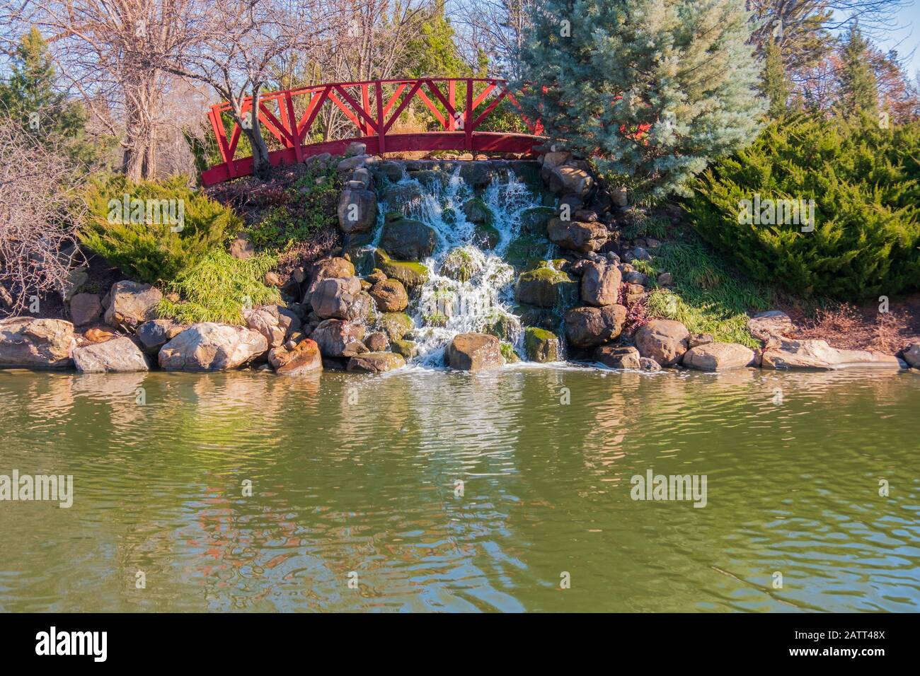 A water attraction of a small truss footbridge and waterfall by a small lake at Bradley Fair shopping center in Wichita, Kansas, USA. Stock Photo