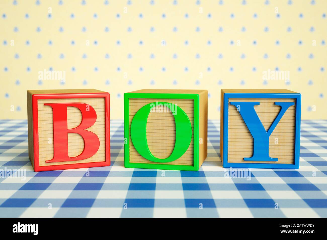 Childrens wooden ABC blocks spelling BOY on a checked tablecloth Stock Photo