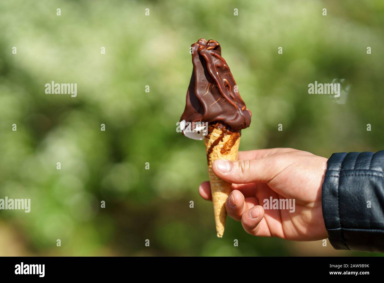 Man holding ice cream cone. Chocolate ice cream Stock Photo