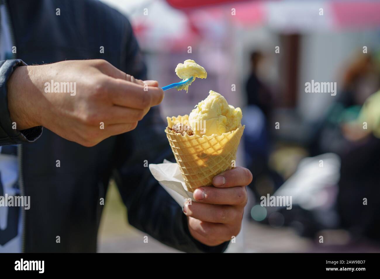 Man holding ice cream cone. Detail of ice cream in hand Stock Photo