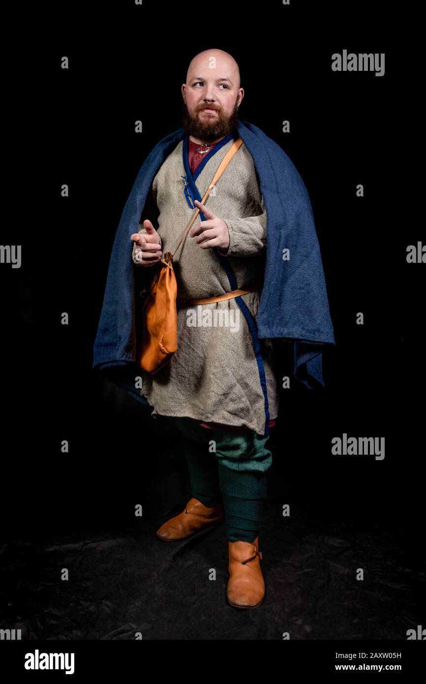 Overweight bearded man in the image of a medieval merchant Stock Photo