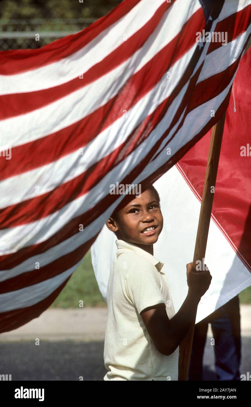 Austin, Texas: Boy with American flag at Juneteenth celebration, Black Emancipation Day parade. ©Bob Daemmrich Stock Photo