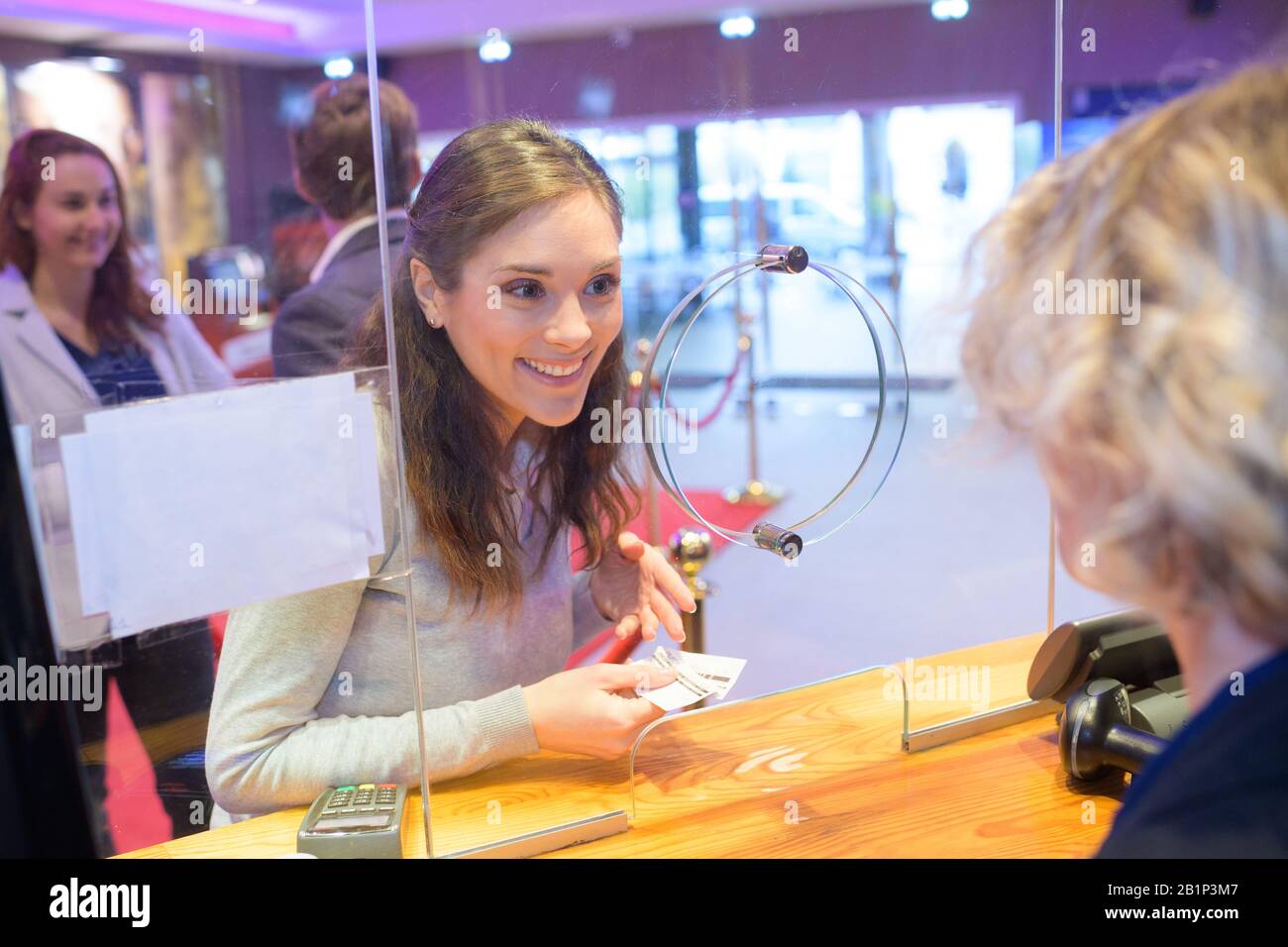 a woman buying a ticket Stock Photo