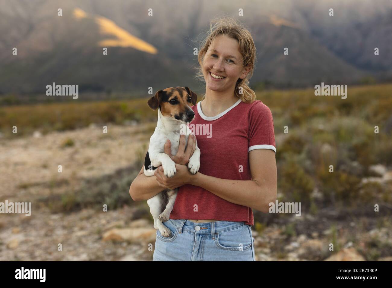 Front view of woman carrying her dog Stock Photo