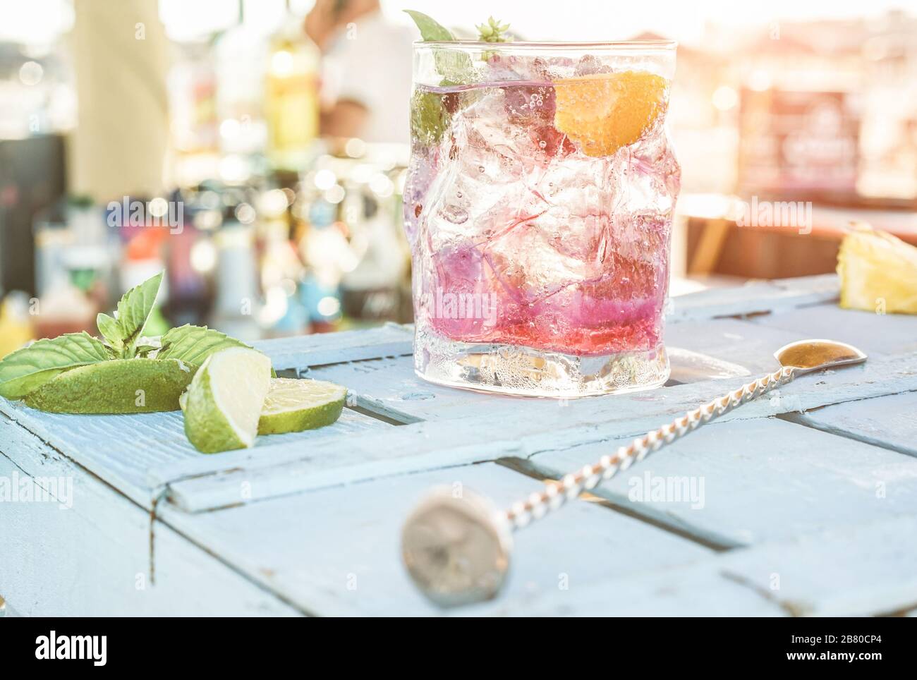 Berries mojito cocktail on blue wood bar counter - Tropical, drinks, party and concept - Focus on glass Stock Photo