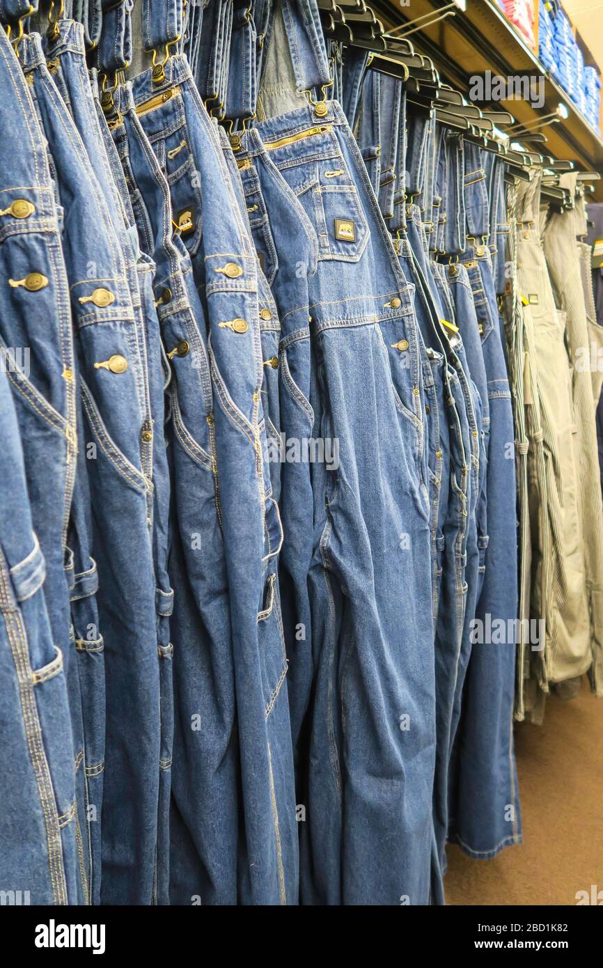 Workwear coveralls for sale in Western shop, USA Stock Photo