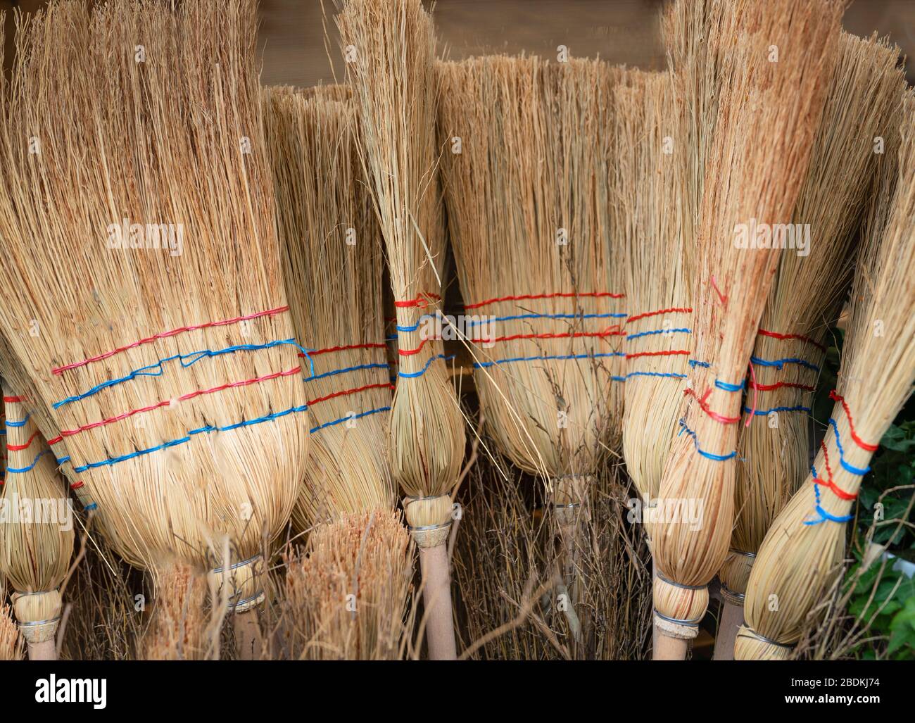 Traditional homemade brooms for sale at holiday market. Stock Photo