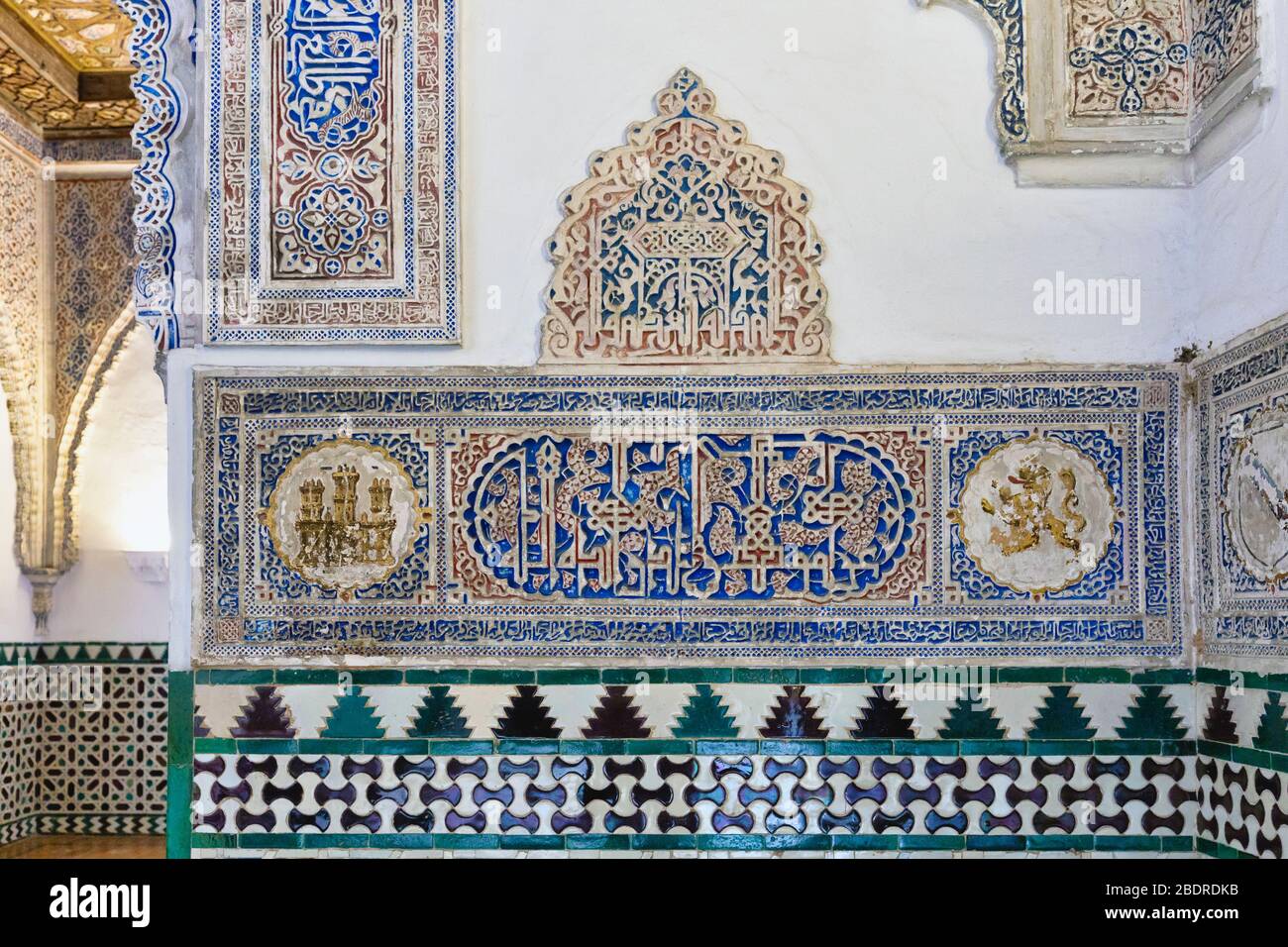 Royal Alcazars, Seville, Seville Province, Andalusia, Spain.   Example of decorative plaster work with Arabic inscriptions.  The monumental complex fo Stock Photo