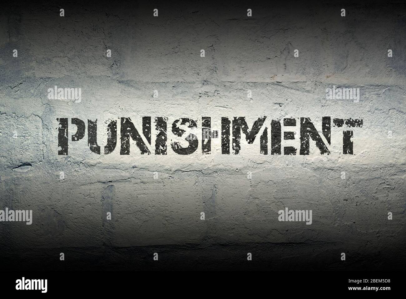 punishment stencil print on the grunge white brick wall Stock Photo